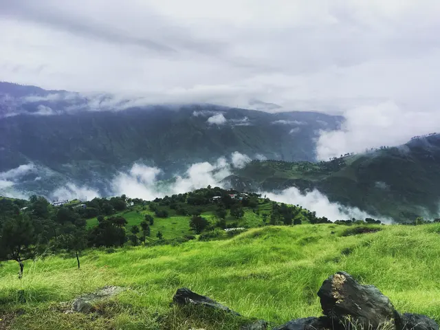 Clouds drifting through green Himalayan mountain pastures